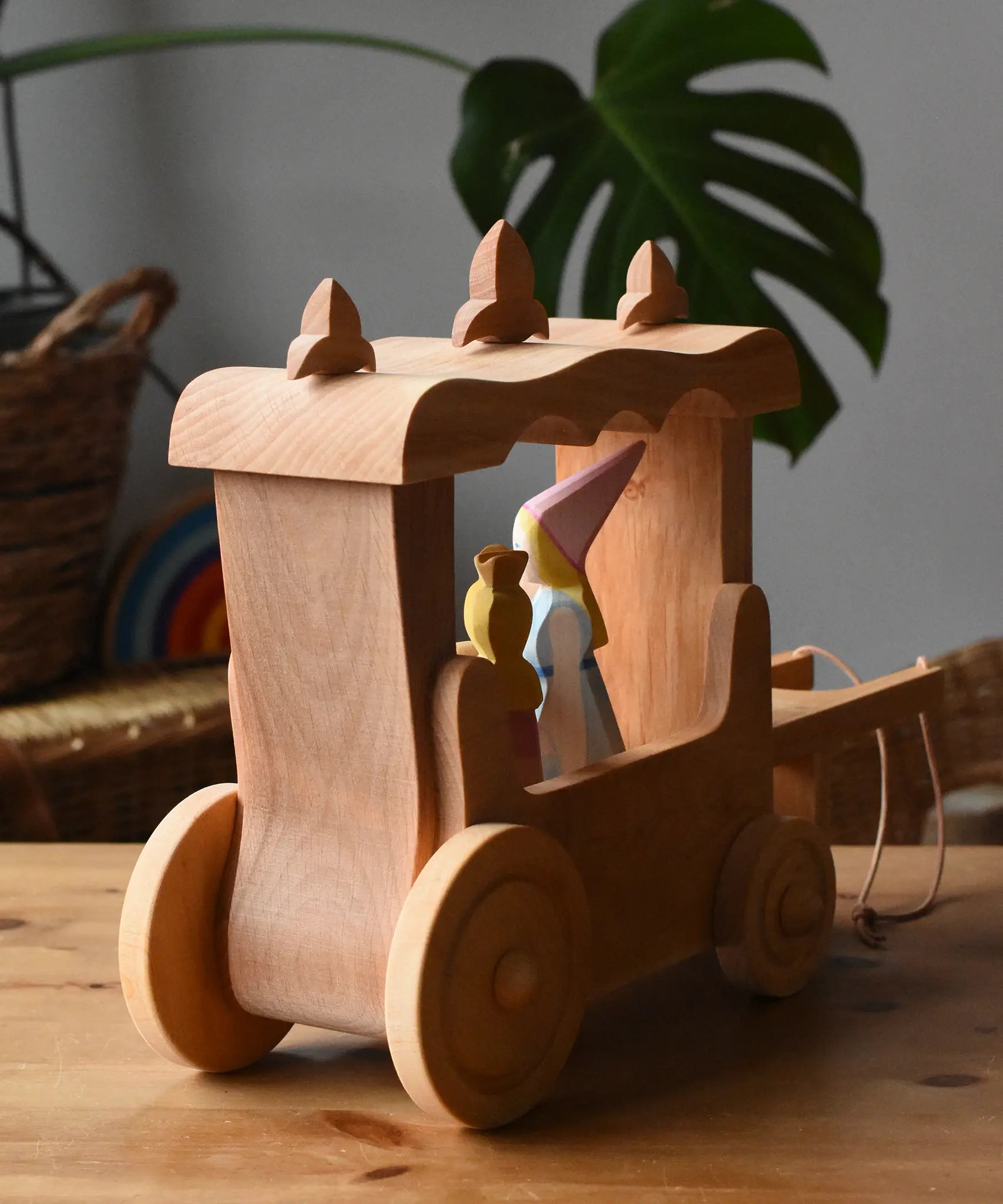 Back of the Ostheimer Wooden Stage Coach toy with princess figures placed inside.
