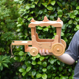 Ostheimer wooden stage coach toy in a child's hand. 
