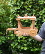 Ostheimer wooden stage coach toy in a child's hand. 