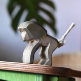Ostheimer standing baboon wooden toy animal figure placed on the roof of the green hutch.