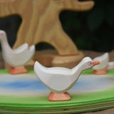 Ostheimer standing goose wooden toy figure placed on a wooden pond scene piece. This wooden toy figure is part of a large collection of expertly handcrafted wooden toys here at Babipur.