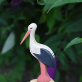 An Ostheimer stork wooden toy figure placed on the top of an Ostheimer bird tree. 