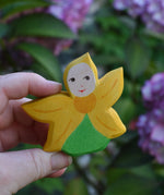 An Ostheimer Sunflower Flower Child being held in an adult's hand to show scale. This wooden figure is part of a large range of expertly hand crafted, Waldorf inspired, wooden toys here at Babipur. 