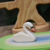 An Ostheimer white swan toy placed on a pond scene piece. 
