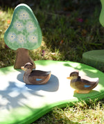 Ostheimer swimming and sitting ducks wooden toy figures placed on a pond piece.