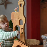 Child reaching for the bell on the Ostheimer tower with stairs. 