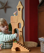 Child reaching for the bell on the Ostheimer tower with stairs. 