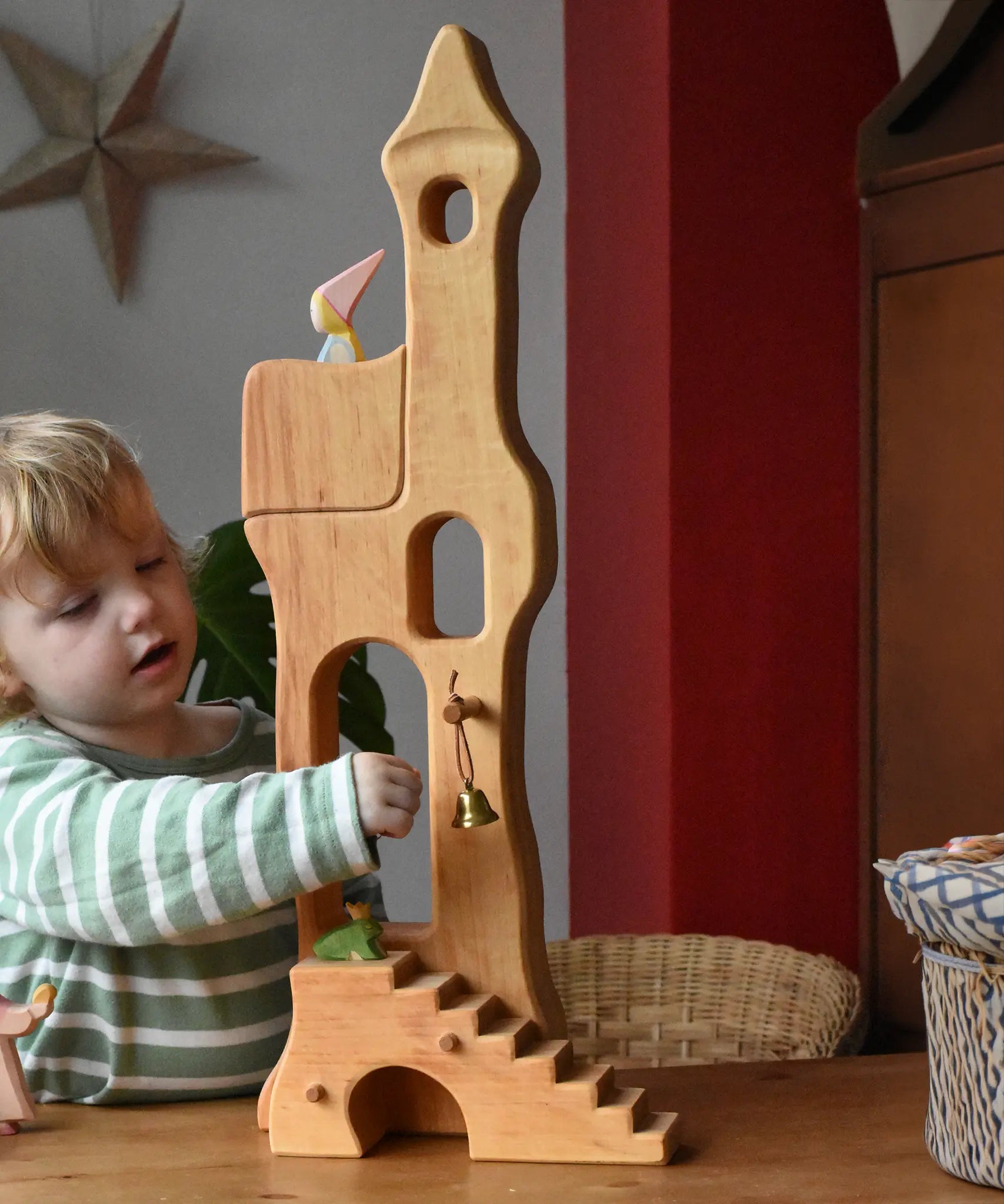 Child reaching for the bell on the Ostheimer tower with stairs. 