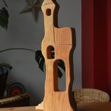 Ostheimer tower with stairs wooden toy building placed on a wooden surface.