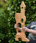 Ostheimer tower with stairs held up in a child's hands.