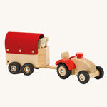 Ostheimer Wooden Tractor toy attached to a sock trailer on a plain background. 