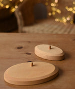 Ostheimer palm tree group wooden support base placed on a wooden surface with the smaller palm tree support base in the background.