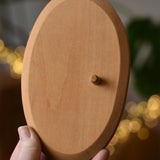 Ostheimer palm tree group wooden support base in an adult's hand. 