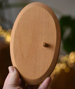 Ostheimer palm tree group wooden support base in an adult's hand. 