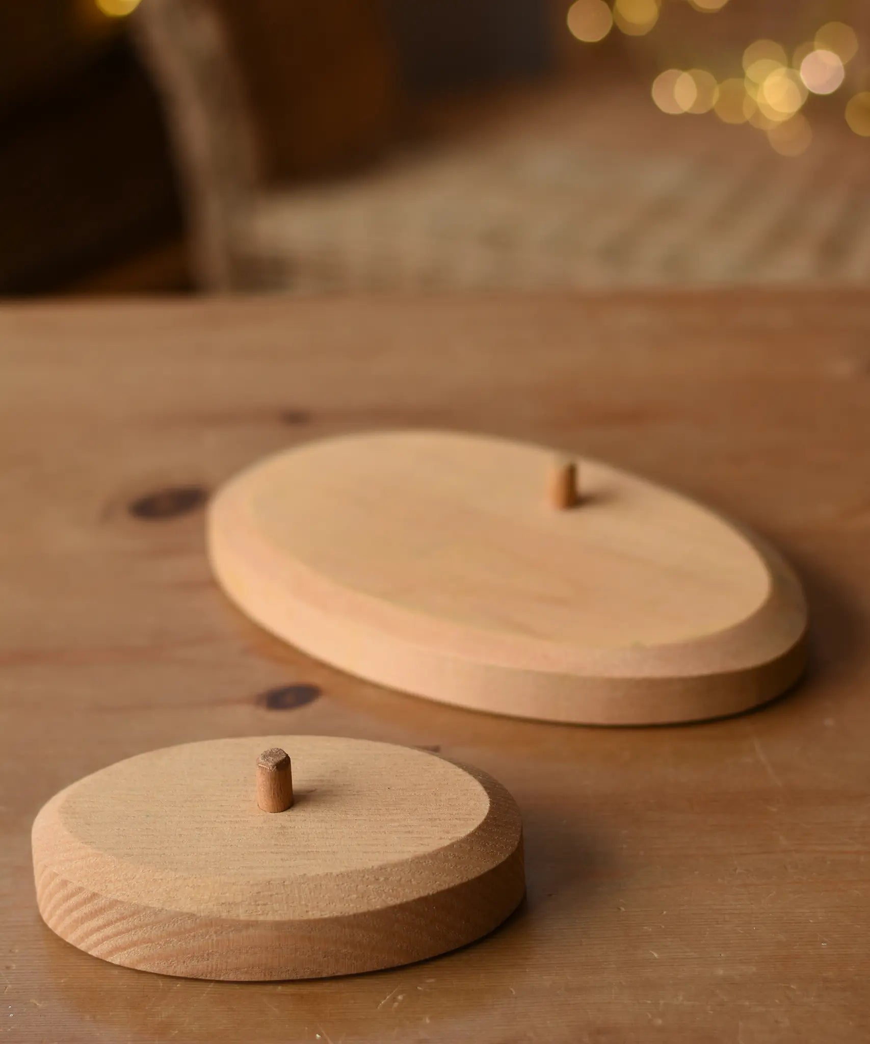 Ostheimer palm tree wooden support base placed on a wooden surface with the larger group base in the background.