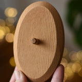 Ostheimer palm tree wooden support base in an adult's hand. 