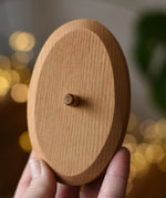 Ostheimer palm tree wooden support base in an adult's hand. 