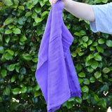 Ostheimer violet purple cotton play cloth in a child's hand.