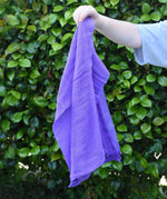 Ostheimer violet purple cotton play cloth in a child's hand.