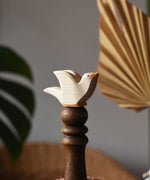 Ostheimer white dove wooden bird figure placed on a wooden stick. 
