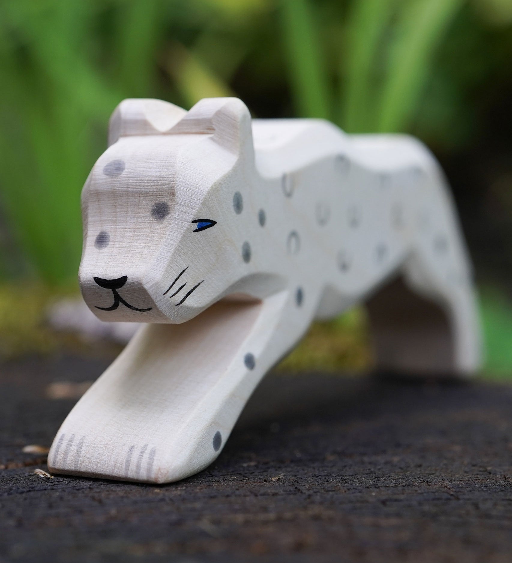 A close up of the Ostheimer snow leopard's face showing the hand painted details. This expertly hand crafted wooden figure is part of a large range of wooden toys here at Babipur.