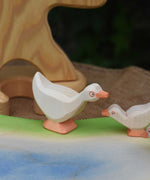 Ostheimer standing goose wooden toy figure placed on a wooden pond scene piece. This wooden toy figure is part of a large collection of expertly handcrafted wooden toys here at Babipur.