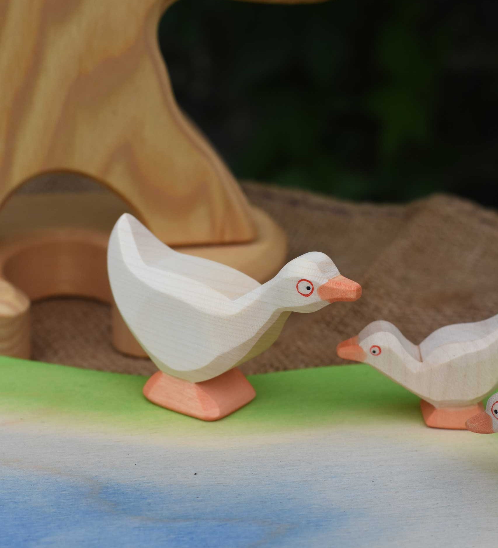 Ostheimer standing goose wooden toy figure placed on a wooden pond scene piece. This wooden toy figure is part of a large collection of expertly handcrafted wooden toys here at Babipur.