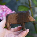 An Ostheimer wild boar sow wooden toy figure shown in an adult's hand for scale. Check out our full range of expertly handcrafted wooden toys here at Babipur.