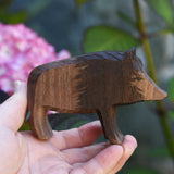 An Ostheimer wild boar sow wooden toy figure shown in an adult's hand for scale. Check out our full range of expertly handcrafted wooden toys here at Babipur.