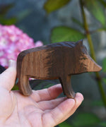 An Ostheimer wild boar sow wooden toy figure shown in an adult's hand for scale. Check out our full range of expertly handcrafted wooden toys here at Babipur.