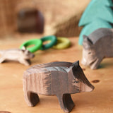 Ostheimer wild boar sow wooden toy figure placed in a small world play scene. 
