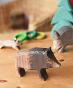 Ostheimer wild boar sow wooden toy figure placed in a small world play scene. 