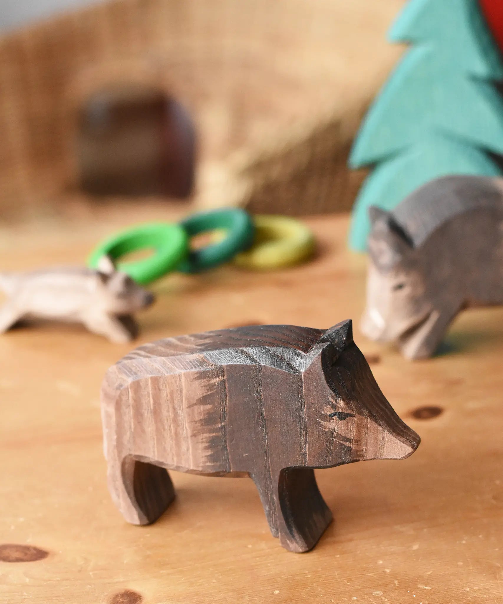 Ostheimer wild boar sow wooden toy figure placed in a small world play scene. 