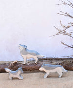 Three Ostheimer wolves wooden toy figures shown in a small world play set up. A full range of expertly crafted wooden toy figures and scenery are available here at Babipur.