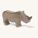 A wooden adult Ostheimer rhino figure on a cream background.