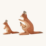 A wooden adult and small Ostheimer kangaroo on a cream background.