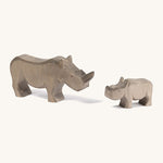 Wooden adult and baby Ostheimer figures on a cream background.
