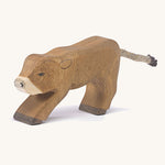 A wooden Ostheimer alp calf drinking on a cream background.