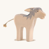 A wooden Ostheimer angry standing donkey on a cream background.