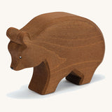 A wooden Ostheimer brown bear figure on a cream background