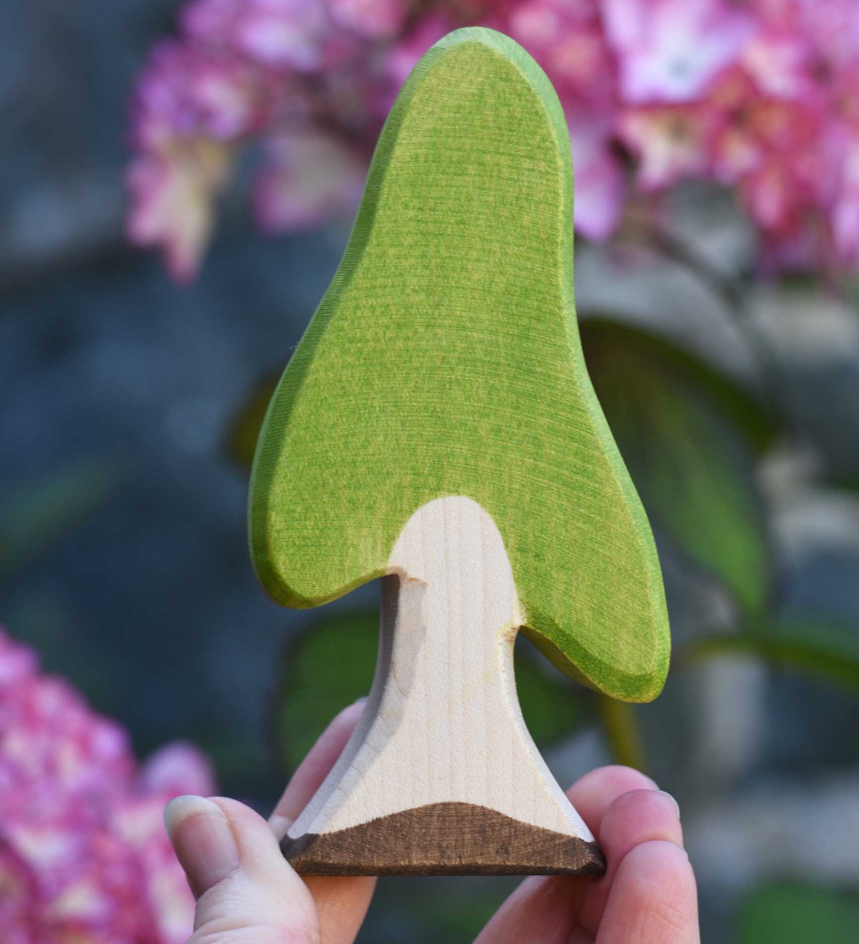 An Ostheimer Wooden Birch Tree Figure held in an adult's hand to show scale. Ostheimer wooden tree figures are perfect for setting scenes in small world and imaginative play. 