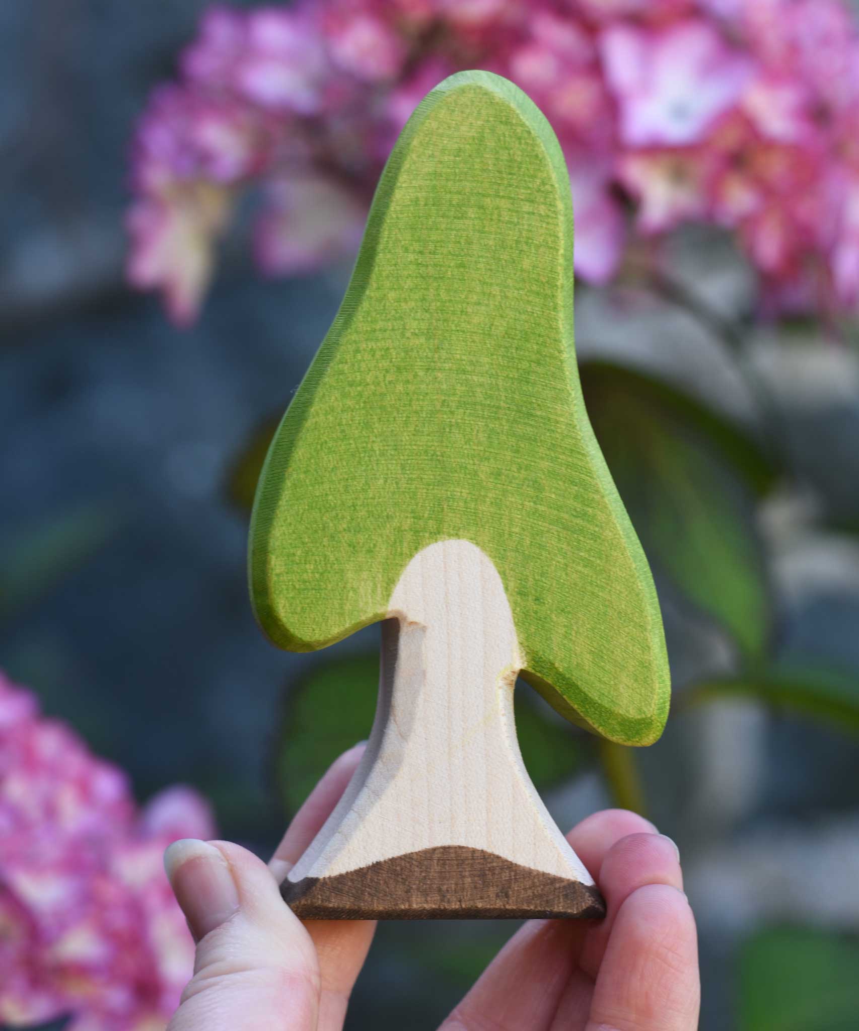 An Ostheimer Wooden Birch Tree Figure held in an adult's hand to show scale. Ostheimer wooden tree figures are perfect for setting scenes in small world and imaginative play. 
