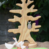 An Ostheimer wooden bird tree placed in a small world play scene with a white owl placed on one of it's branches.