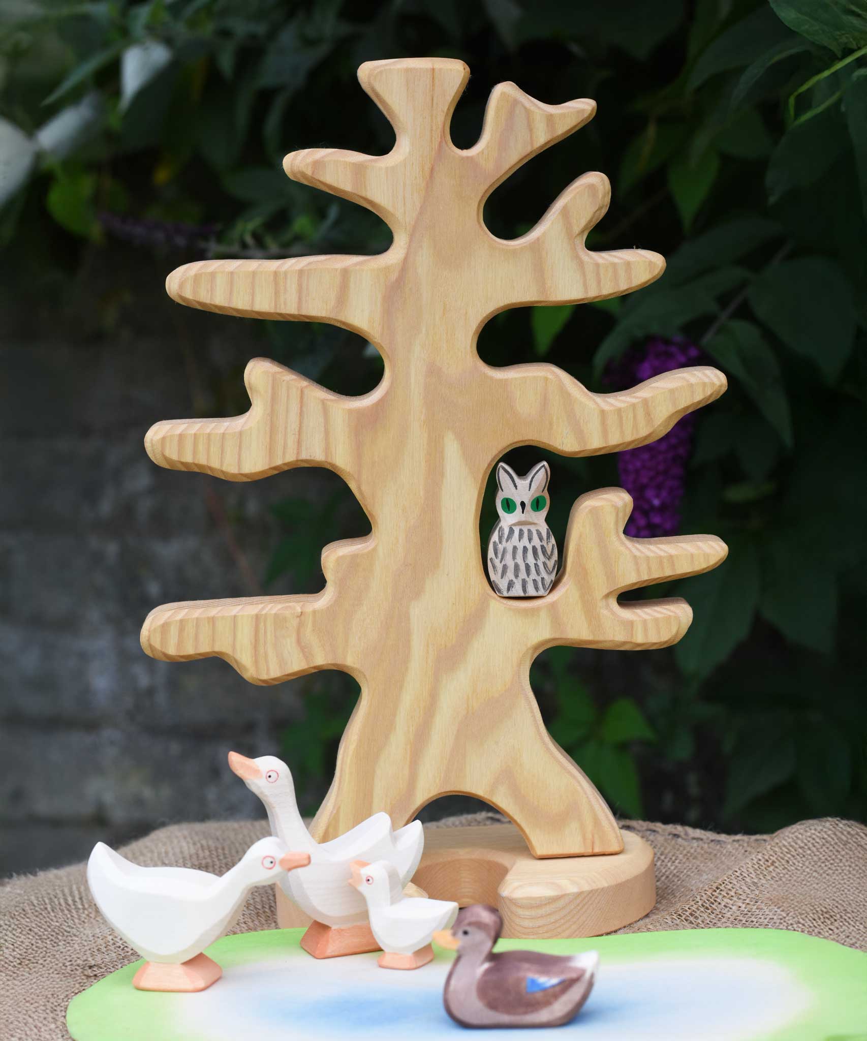 An Ostheimer wooden bird tree placed in a small world play scene with a white owl placed on one of it's branches.