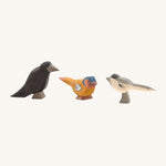 A raven, bullfinch and a magpie Ostheimer figure on a cream background.