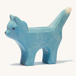 A blue wooden Ostheimer bremer standing cat figure on a cream background.