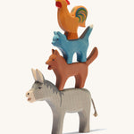 Ostheimer Town Musicians of Bremer, 4 wooden animal toy set stacked on top of each other on a cream background