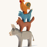 Ostheimer Town Musicians of Bremer, 4 wooden animal toy set stacked on top of each other on a cream background