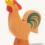 A brown wooden Ostheimer bremer rooster on a cream background.