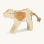A brown wooden Ostheimer calf drinking figure on a cream background.
